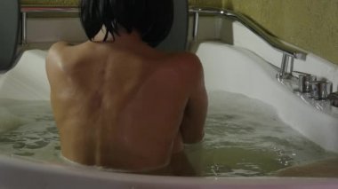 kabarcık banyo güzel bir kadın. Arkadan görünüm, çıplak kadın geri. ağır çekim