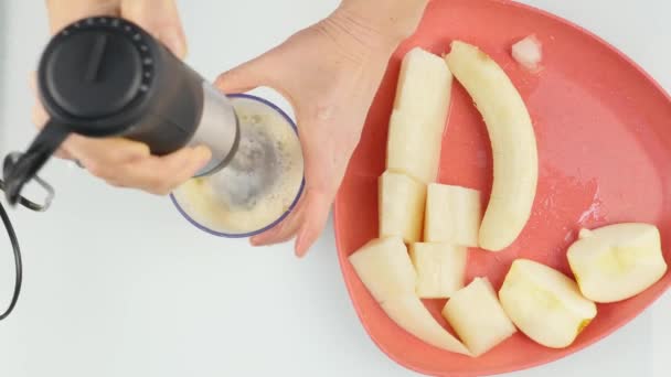 Woman making a milky fruity cocktail in a blender, smoothies preparation. 4K — Stock Video