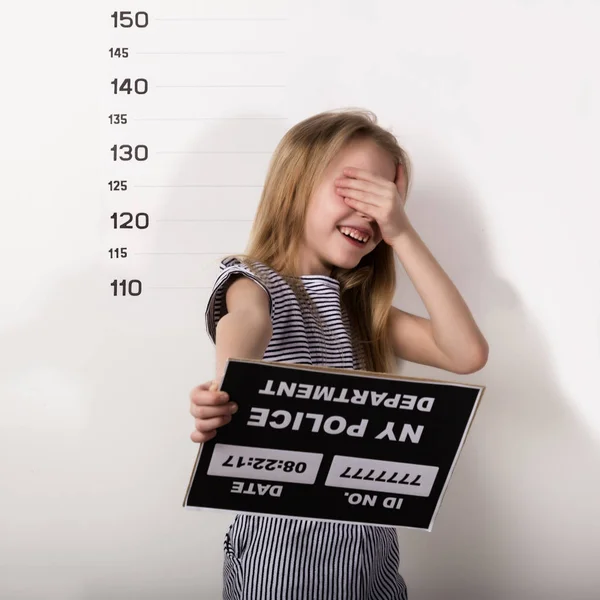 Young beautiful blonde child with a sign covers his face with his hand, Criminal Mug Shots — 스톡 사진