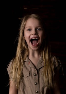 beautiful lovely little blonde girl with different emotions on a dark background clipart