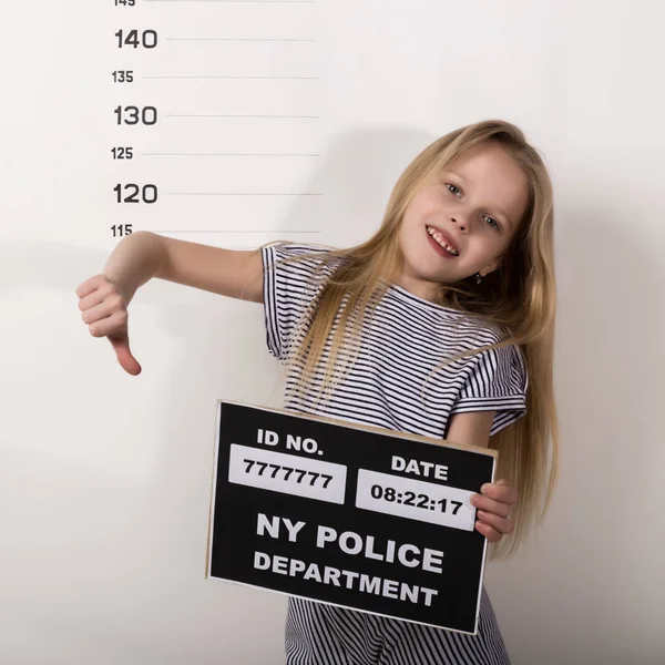 Young beautiful blonde child with a sign, Criminal Mug Shots. difficult children, social tension — 스톡 사진