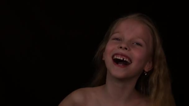 Young girl with live emotions under water drops. child screaming on a dark background. expression of different emotions — Stock Video