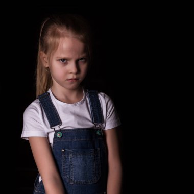 beautiful blonde little girl on a dark background. She stands in different poses and shows different emotions. free space for your text clipart
