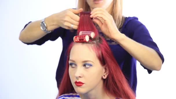 Estilista feminino criando penteado perfeito com cachos grandes para a mulher ruiva jovem — Vídeo de Stock