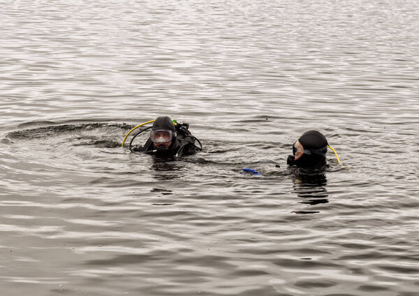 scuba diving in a mountain lake, practicing techniques for emergency rescuers. immersion in cold water