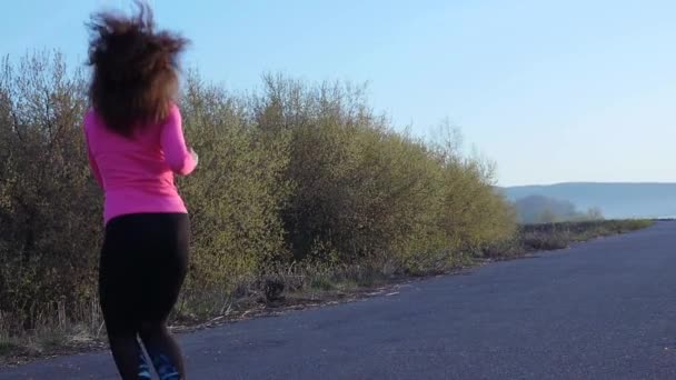 Mujer atlética va a practicar deportes en la orilla del río al amanecer. cámara lenta — Vídeos de Stock