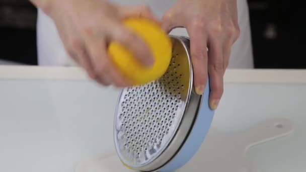 Confectioner cuts the orange peel, citrus zester grating peeling orange peel — Stock Video