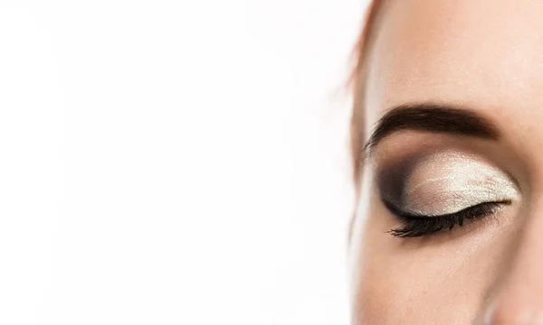 Close-up womans eye with professional makeup smokey eye, on a white background. free space for text — Stock Photo, Image