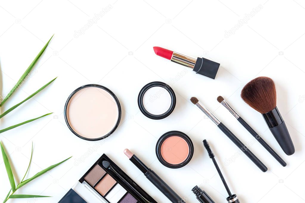 Makeup cosmetics tools background and beauty cosmetics, products and facial cosmetics package lipstick, eyeshadow on the white background, top view and copy space.  Lifestyle Concept
