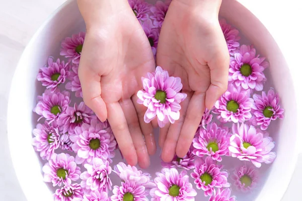 Spa treatment and product for female feet and manicure nails spa with pink flower, copy space, Thailand. Healthy Concept