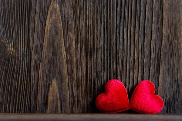 Valentines Day.  Sewed pillow red hearts clothespins on the old wood planks, vintage tone.  Happy lovers day card mock up, copy space.