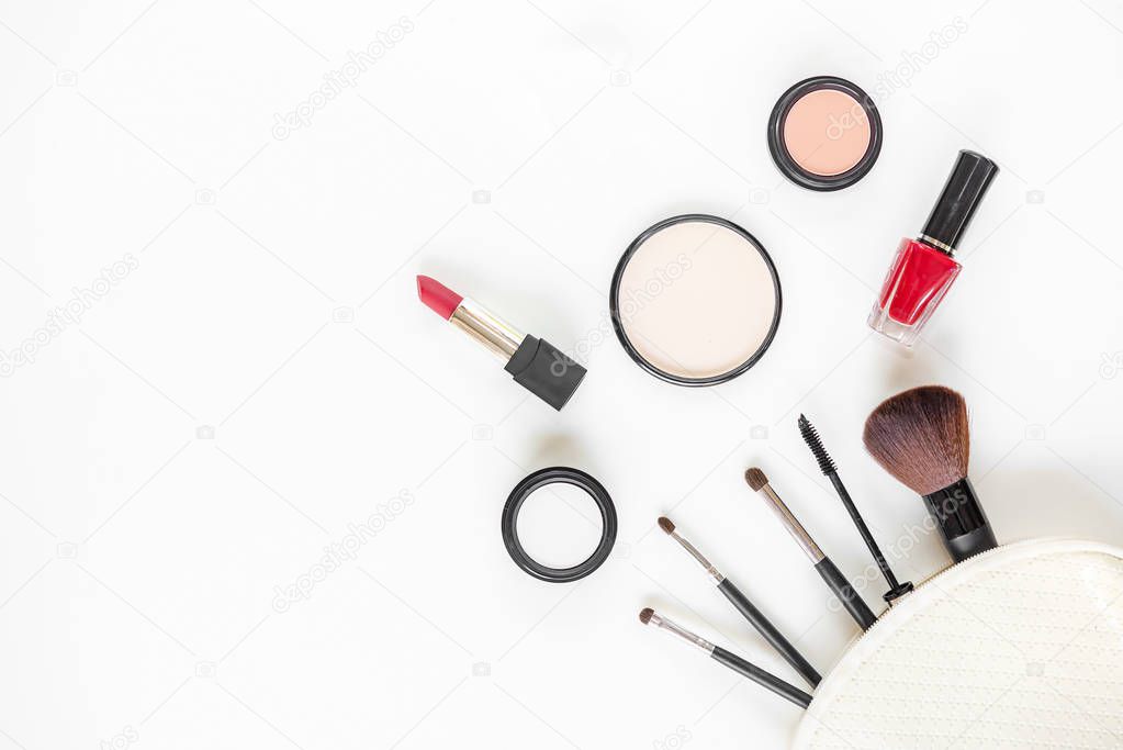 Top View.  Makeup cosmetics tools and beauty cosmetics, products and facial cosmetics package lipstick, eyeshadow on the white background, copy space.  Lifestyle Concept