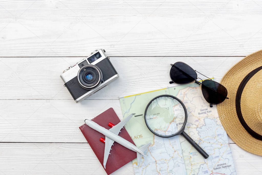 Travel Plan. Traveler planning trips summer vacations with Traveler's accessories, retro camera, sunglass and passport in summertime. Top view and copy space for banner