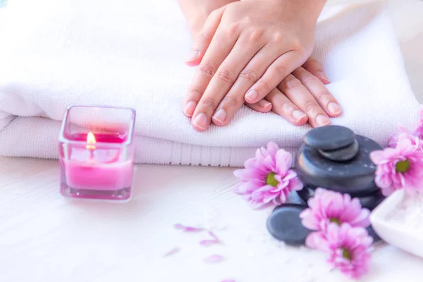 Spa treatment and product for female feet and manicure nails spa with pink flower and rock stone, copy space, select focus, Thailand. Healthy Concept