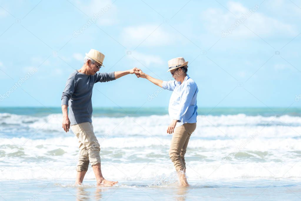 Asian Lifestyle senior couple dancing on the beach happy and relax time.  Tourism elderly family travel leisure and activity after retirement in vacations and summer.