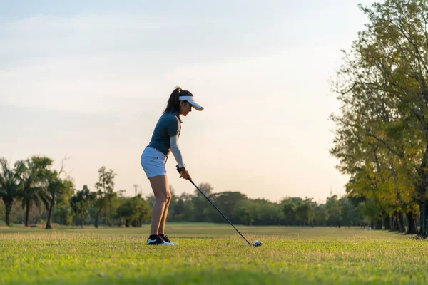 Golfer sport course golf ball fairway. People lifestyle woman playing game golf tee of on the green grass. Asia female player game shot in summer. Healthy and Sport outdoor