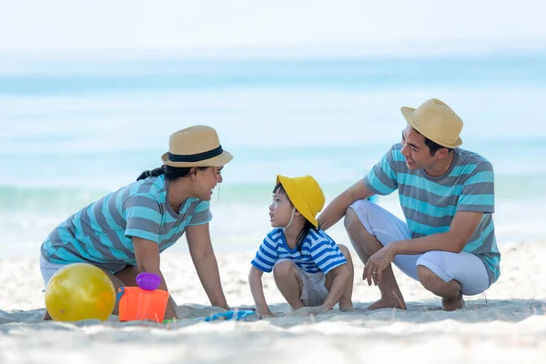 Asian happy family have fun on the beach.  Traveling backpack for travel in vacations for leisure and destination.  Family tourism travel in summer and holiday.  Travel and Family Concept