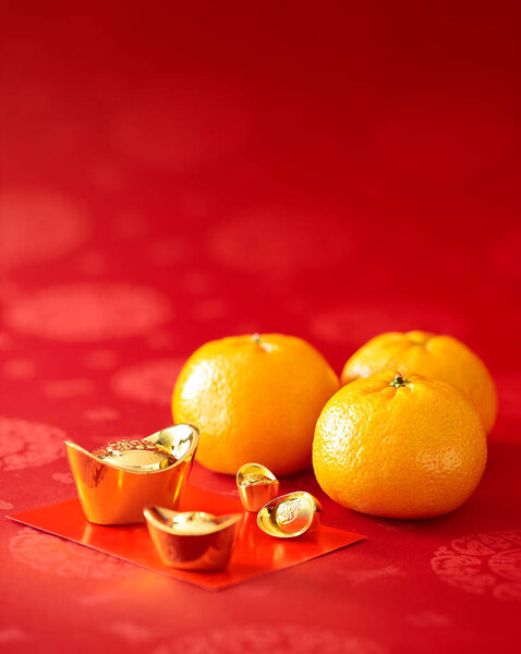 Chinese New Year - Mandarin orange, gold sycee (Foreign text means wealth) and red packet