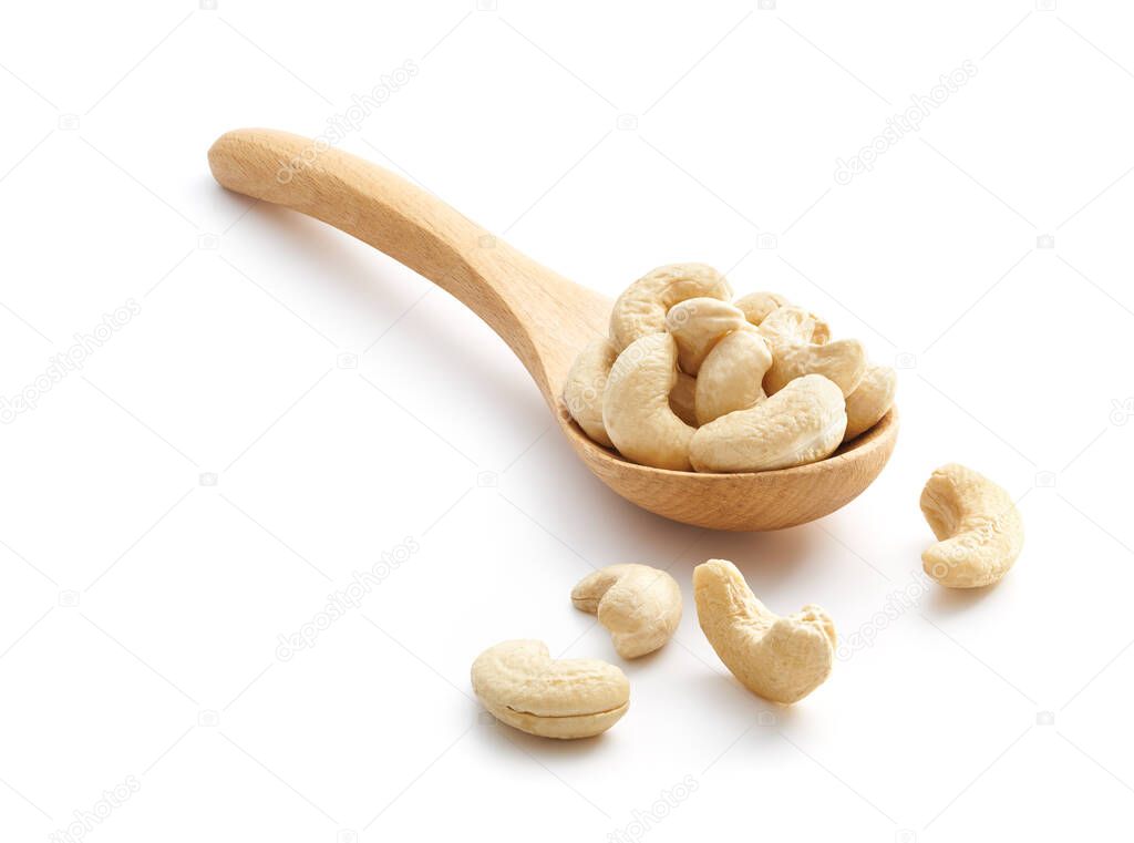Cashew Nuts on wooden spoon isolated over white background