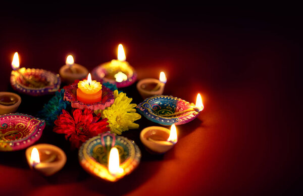 Colorful clay diya lamps lit during diwali celebration
