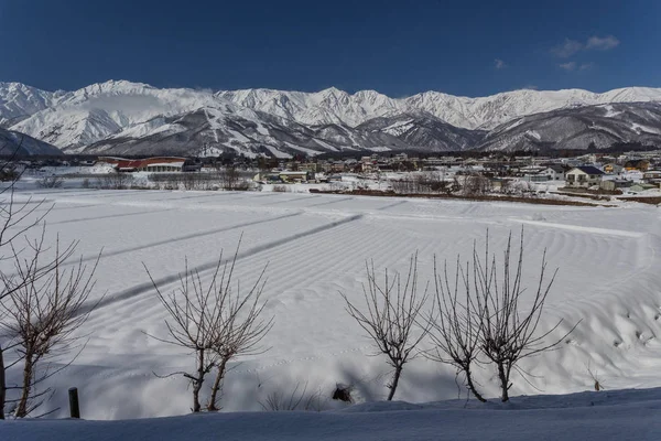 Snowy city surrounded by winter nature, central Japan.