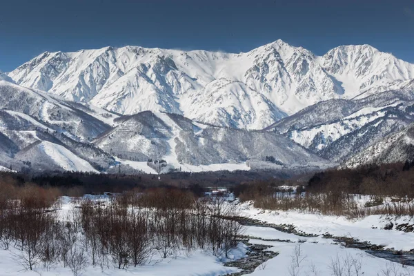 Snowy winter nature with mountains and trees view in central Japan