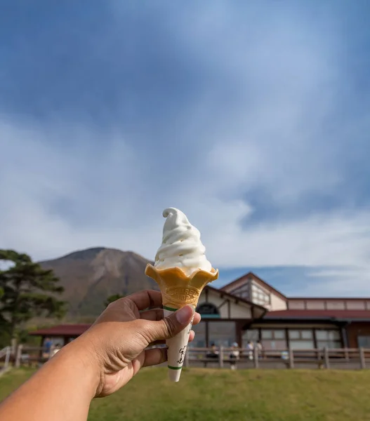 Woman holding ice cream in autumn in Japan