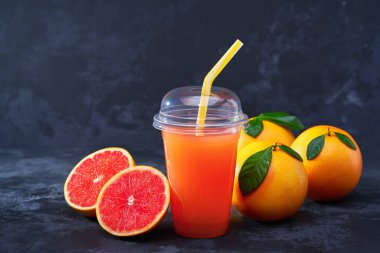 Plastik kap karanlık tablo taze meyve ile organik taze greyfurt suyu