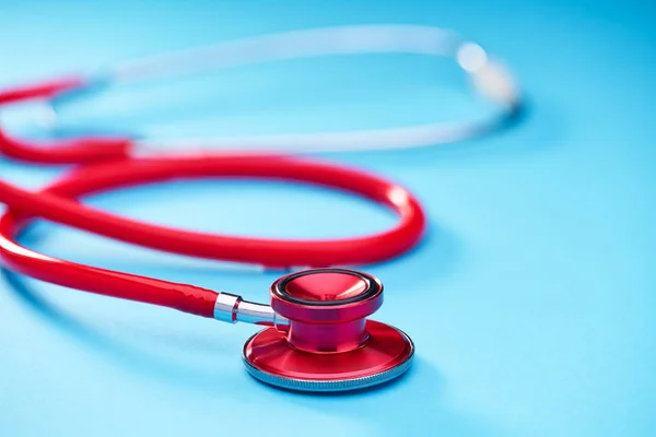 Red Stethoscope Blue Table Background Copy Space Text Selective Focus — Stock Photo, Image