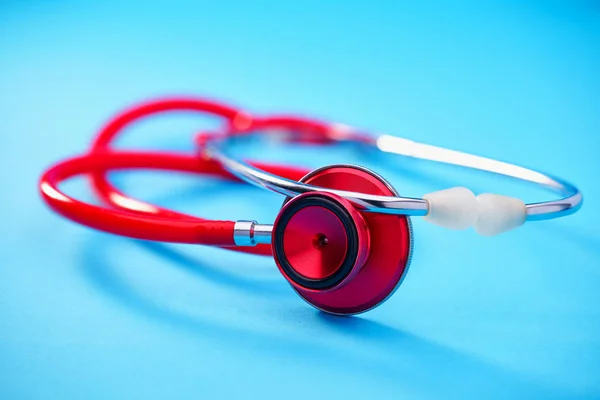 Red Stethoscope Blue Table Background Copy Space Text Selective Focus — Stock Photo, Image