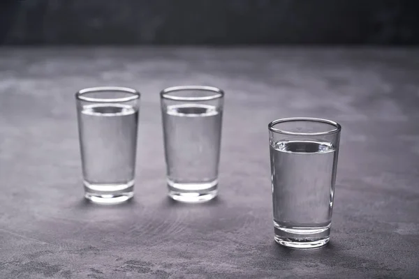 Three Vodka Shots Black Table Selective Focus — Stock Photo, Image