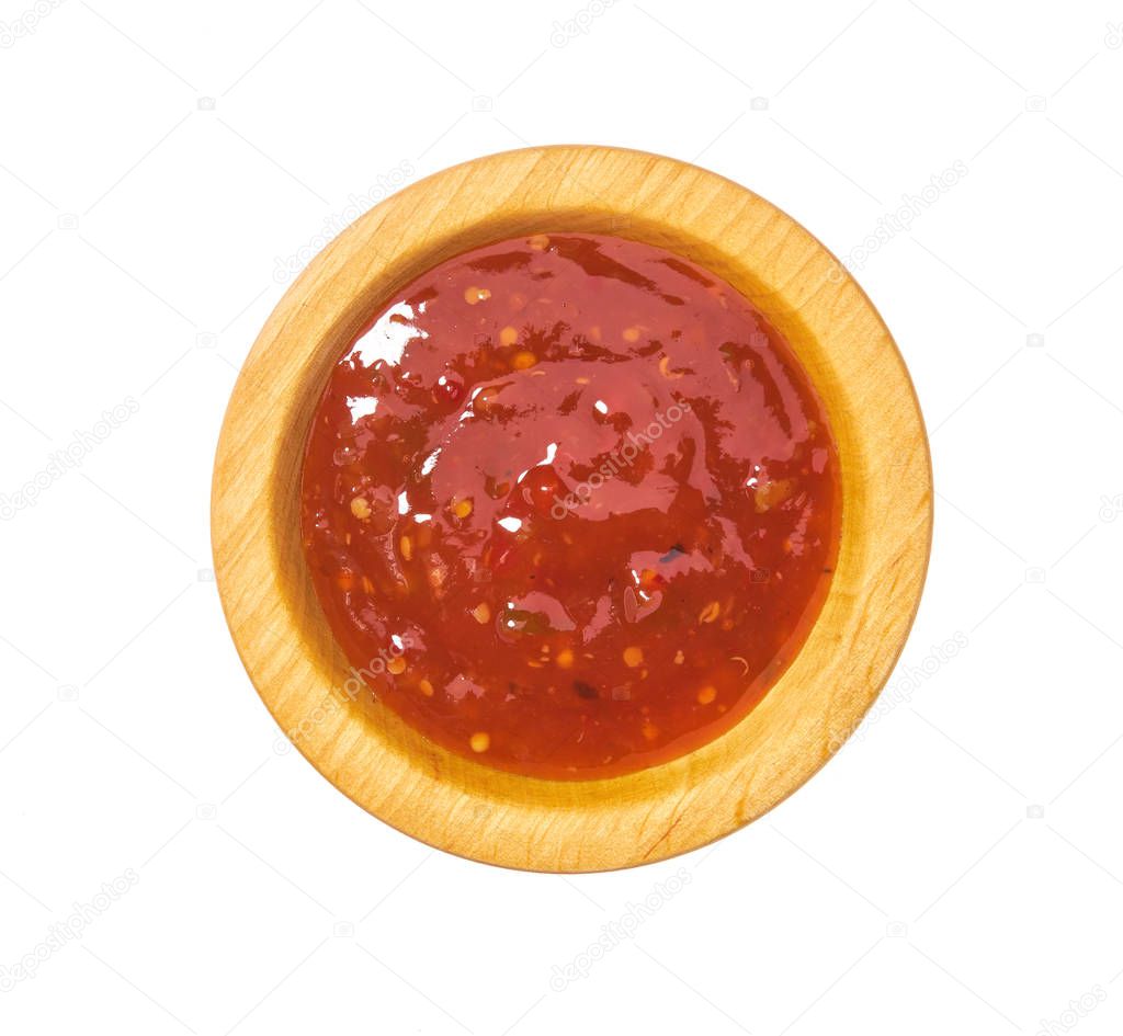 Red hot chilli pepper sauce  in wooden bowl isolated on white background.