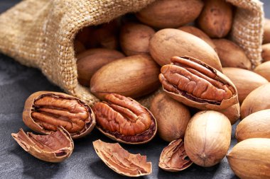 Siyah masa üzerinde çanta içinde Pecan. Yığın veya ceviz yığını.