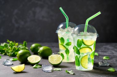 Kireç dilimleri, buz küpleri ve fresile ferahlatıcı kokteyl mojito