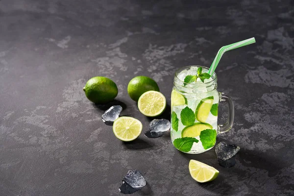 Fresh mojito cocktail with lime slices, ice cubes and fresh mint — Stock Photo, Image