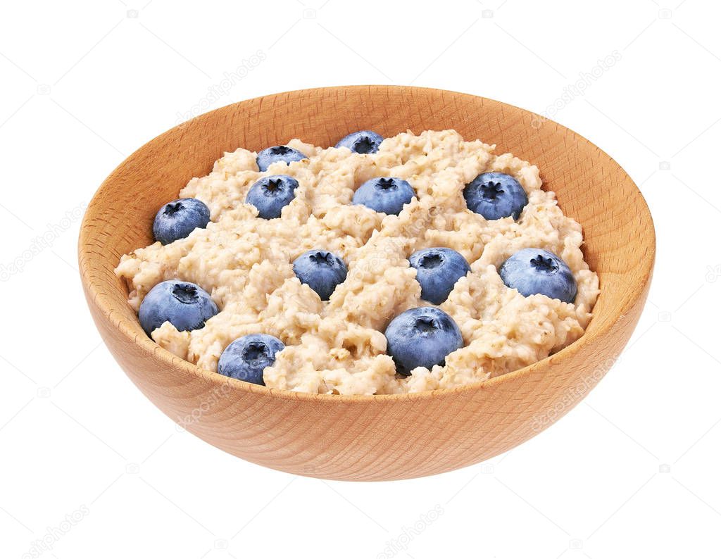 Oatmeal porridge  with blueberry  in wooden bowl isolated. Delic