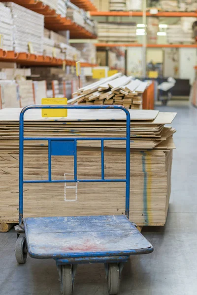 shop of building materials. Racks with boards, wood and building materials. Packed boards in the building store. dry flat boards stacked together. close-up. building materials.