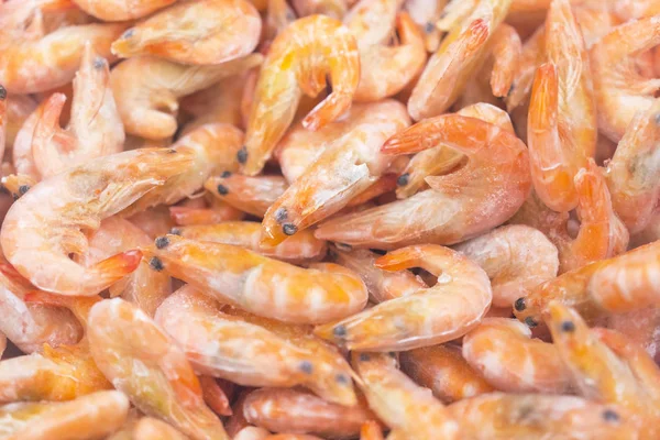 Frozen shrimps in ice. A lot of royal shrimp close-up