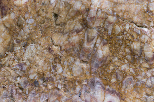 Brown cracked stone close-up background