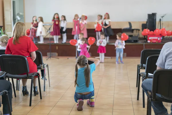 A children\'s holiday in the kindergarten. Speech of children in the kindergarten in the hall on the stage. blurry.