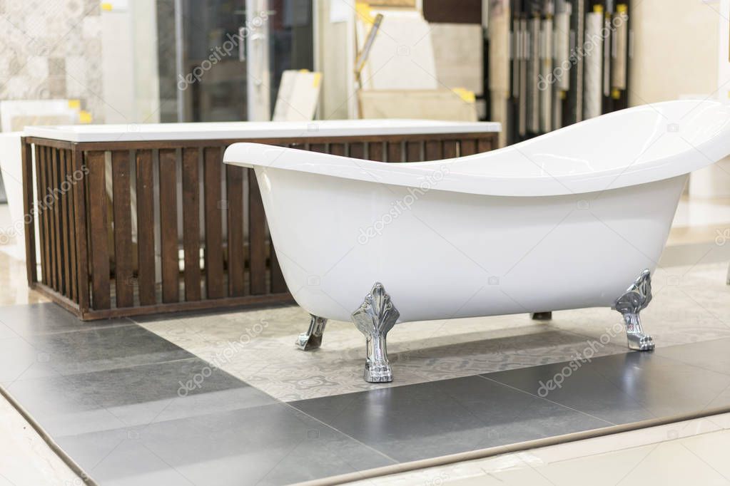 hite bath in the building store. baths in the plumbing store. Sanitary engineering shop. White bathrooms. shop baths. Plumbing. new baths. Bathroom on beautiful forged legs.