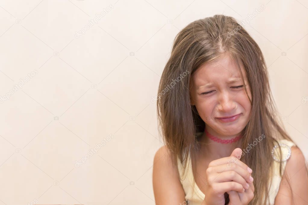 The little girl is sincerely crying. The concept of child insult, depression and misunderstanding.