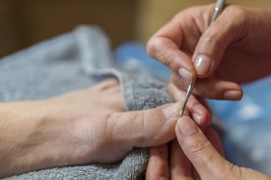 Pedikür yaparken profesyonel aletler kullanarak Master. Pedikür tedavisinde güzellik salonu. Kavram kapatın.