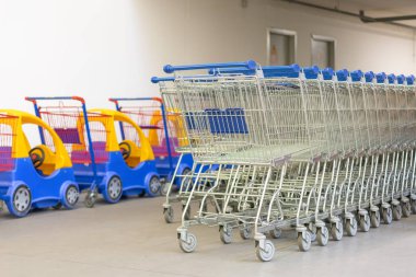 Tema alışveriş süpermarket alışveriş arabaları. Alışveriş arabaları mavi kulplu ve çocuk arabaları, satır
