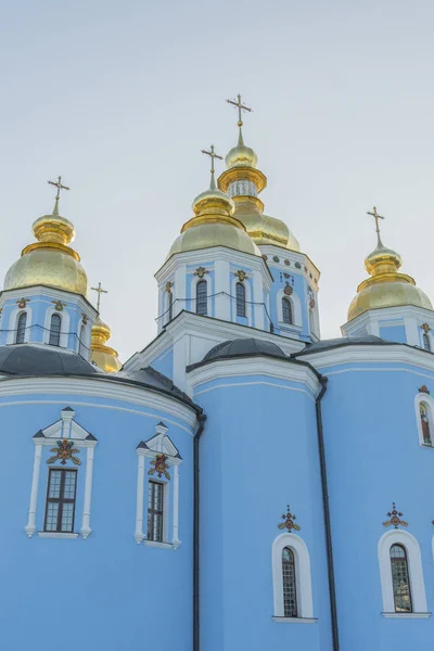 Golden domes of St. Michael Cathedral in Kiev, Ukraine. St. Michael\'s Golden-Domed Monastery - famous church complex in Kiev, Ukraine. Vertical photo.