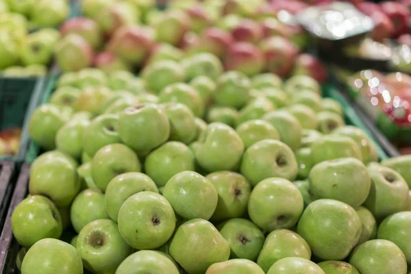 Green apples in a box in the store. green apples in boxes on market shelves. grocery shopping concept. healthy food