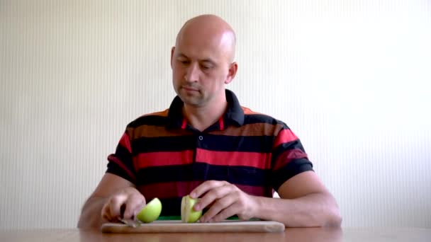 Ένας άνθρωπος επιχρίσματα το πρόσωπό του με ένα μήλο για την αναζωογόνηση δερμάτων. Μάσκα μήλα για το πρόσωπο. μέσα για την αφαίρεση ρυτίδων — Αρχείο Βίντεο