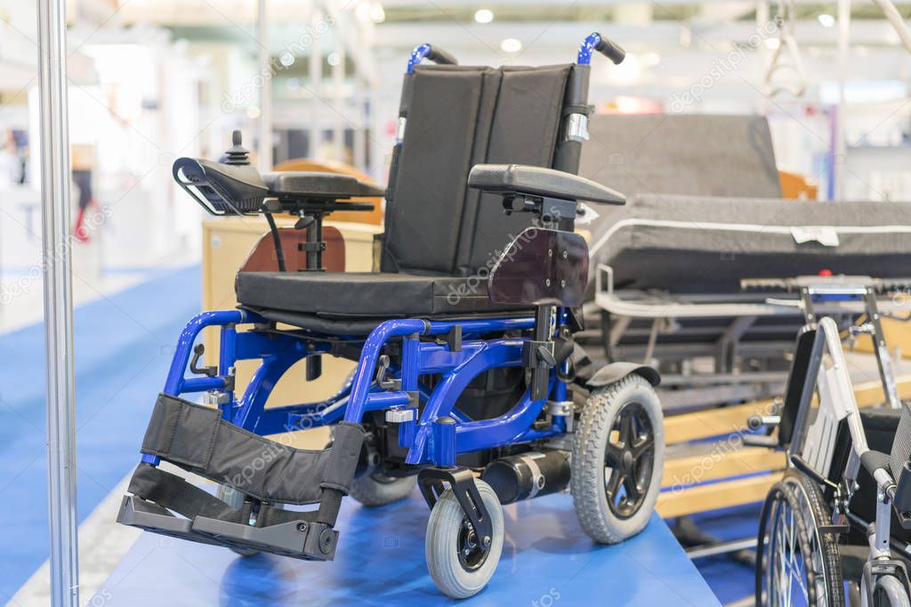 Wheelchair at a medical exhibition. Wheelchair with electric motor.