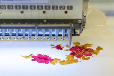 Computerized embroidery machines. sewing machine on blurred background. textile workshop. closeup. clipart