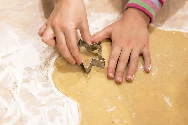 The child makes pastry with dough from forms.